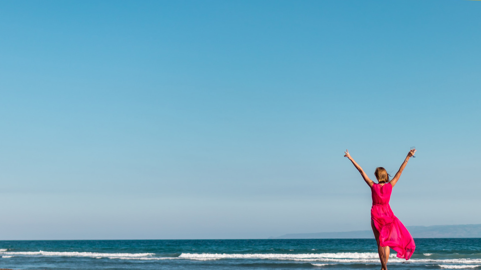 woman-wearing-pink-dress-standing-on-shore-2316088